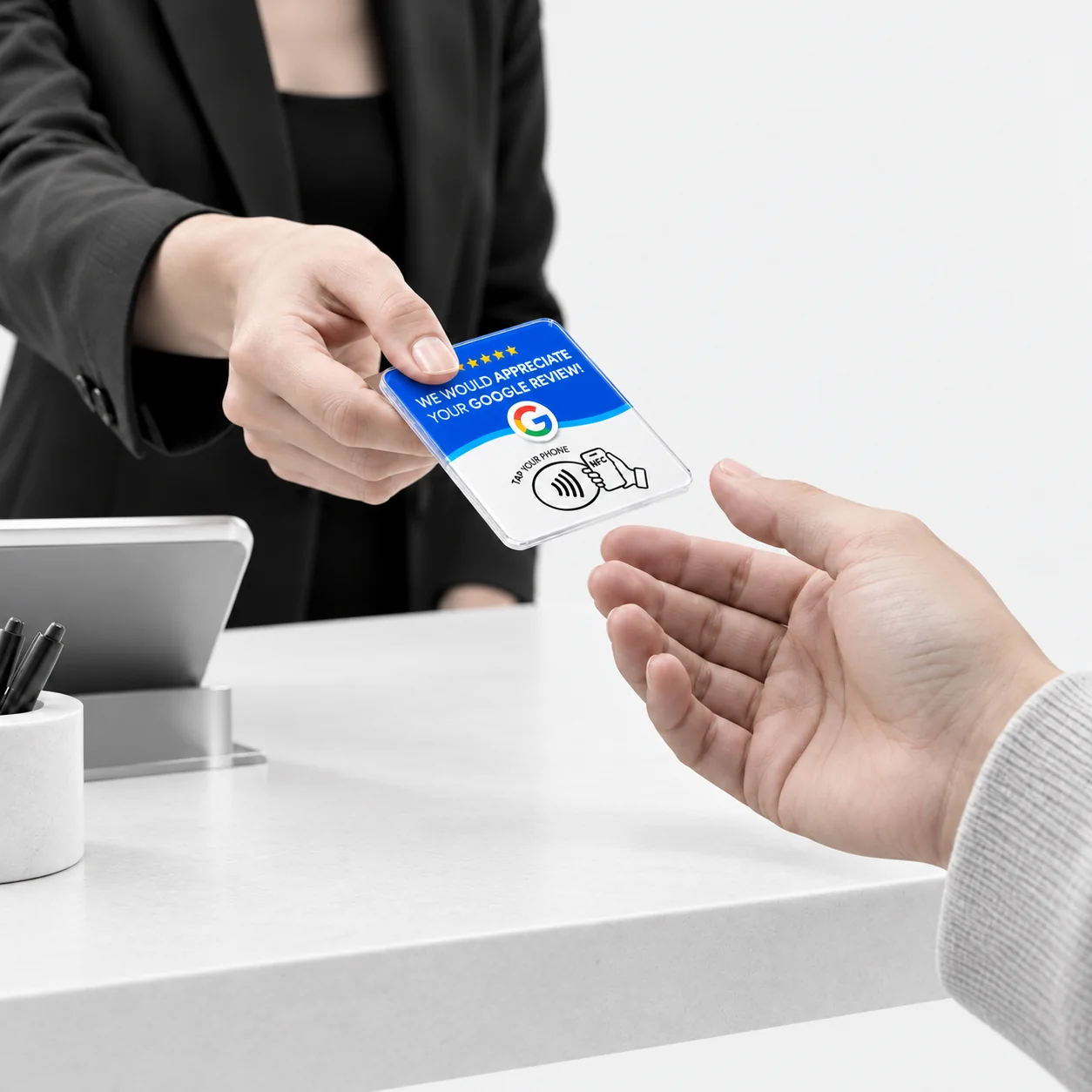 A business owner handing the Google review card to a customer