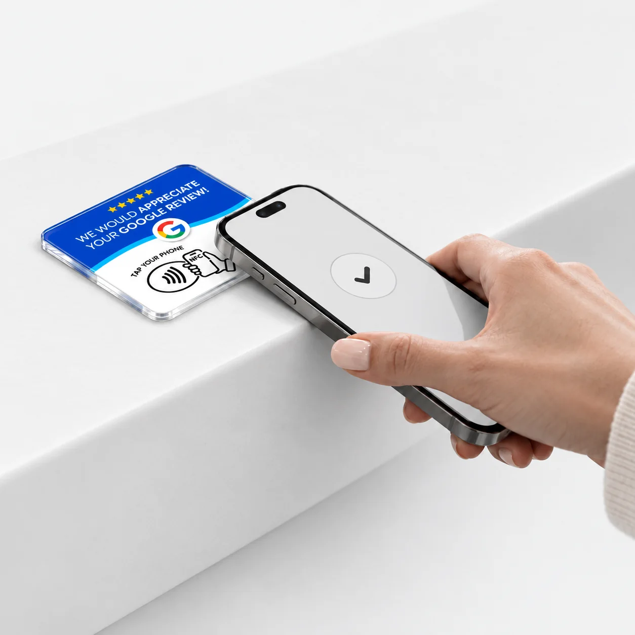 A customer tapping a smartphone on the review card